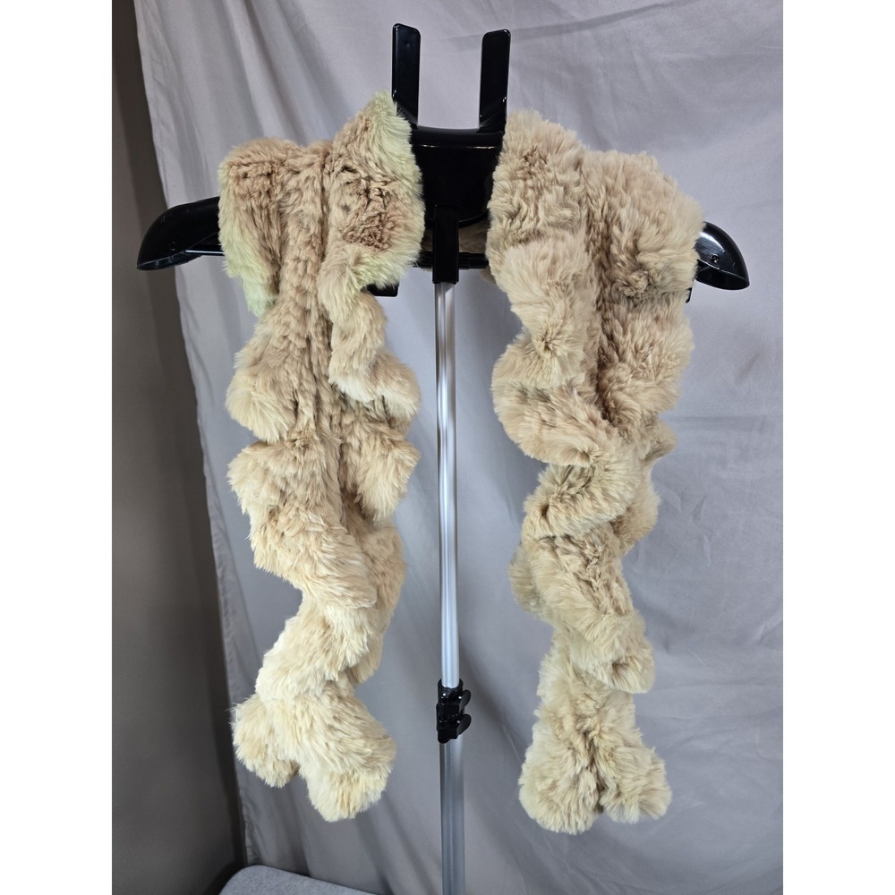 beige rabbit fur stole is a luxurious accessory featuring a distinctively...
